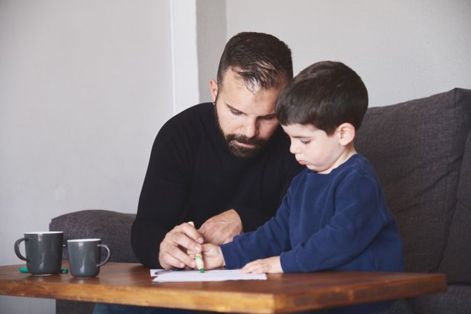 Father and son drawing together