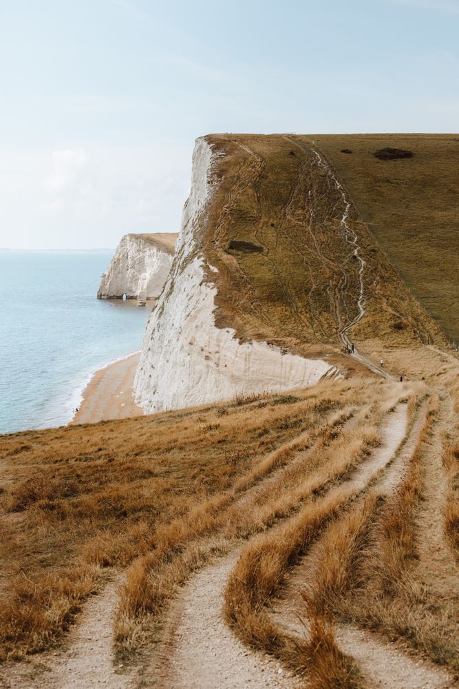 Limestone cliffs with withered grass by water