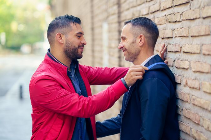 Side view of male couple in a romantic moment on the street