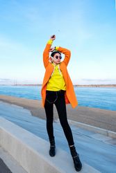 Woman with headphones on the coast