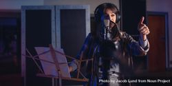 Woman recording a song for her new album in recording studio 4OYoL0