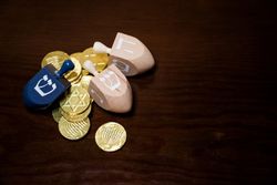 Top view of three dreidels with gelt for Hanukkah