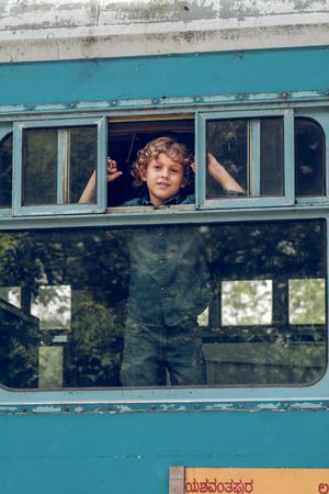 Content boy in train window