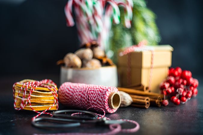 Christmas card concept with dried fruit, strings, cinnamon and holly