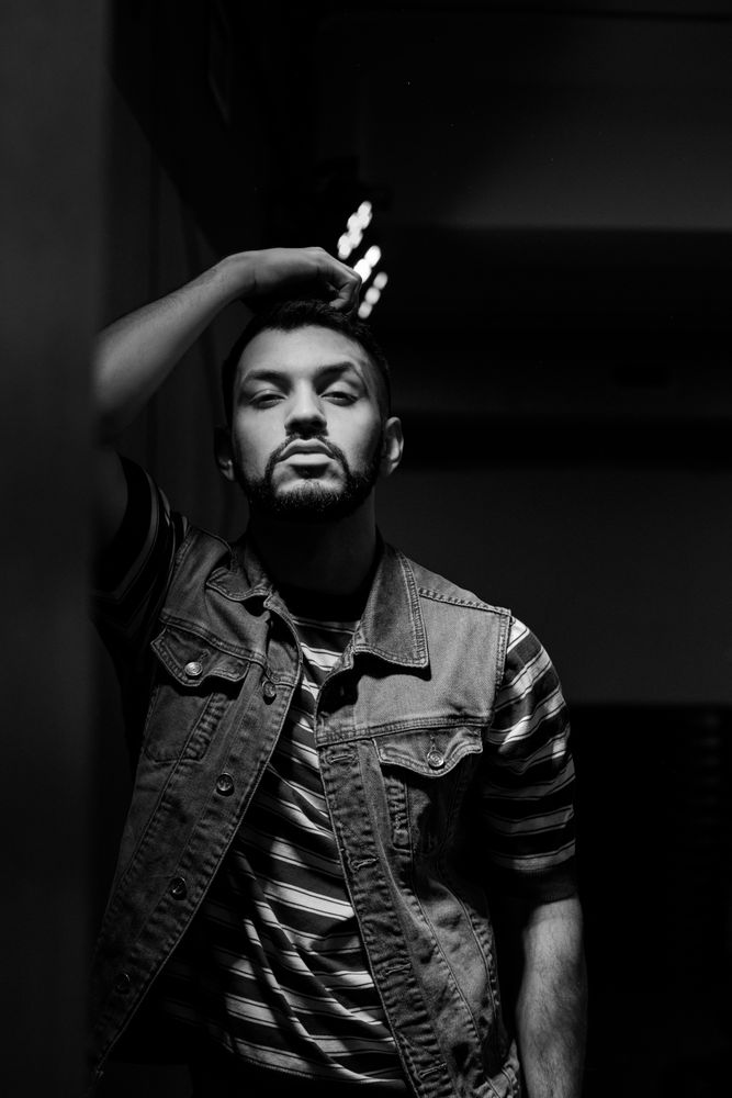 bearded man dancing in spotlight