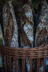 Golden rustic baguettes in basket