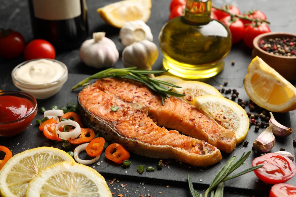 Composition with tasty grilled salmon on dark background, close up