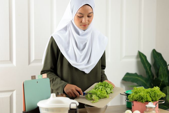 Young Mom Making Salad for Her Small Family