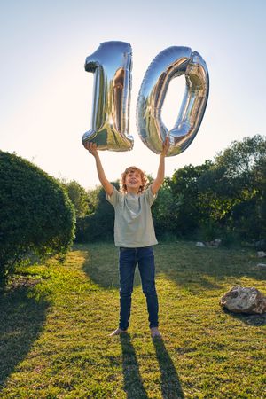 Happy boy with balloon number 10