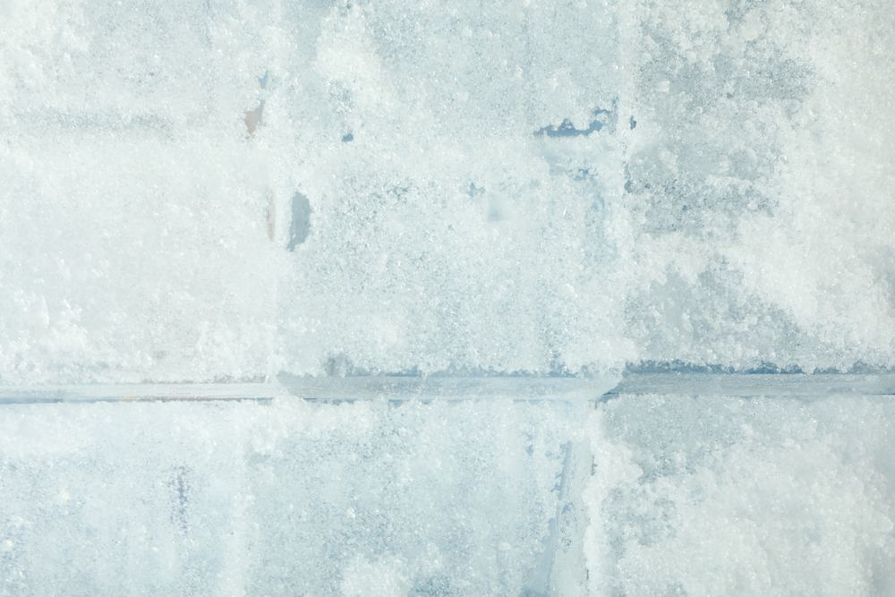 Top view of rows of tightly stacked ice cubes