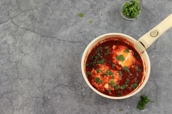 Shakshuka in a Frying Pan. Eggs Poached in Spicy Tomato Pepper Sauce.