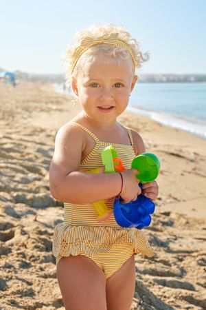 Little girl with toy on beach