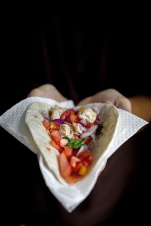 Woman's hands holding Mexican Tacos