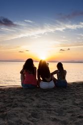 Peaceful fellows embracing on seashore