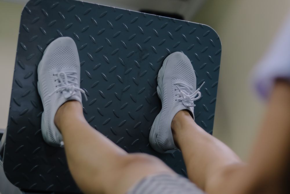 close up showing a woman's legs on a leg press machine