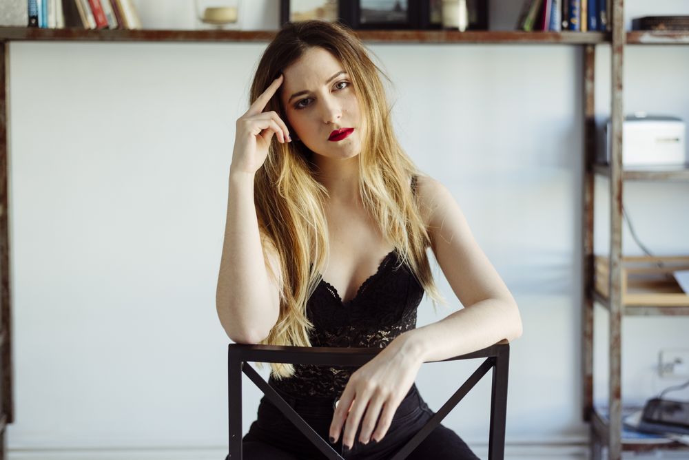 woman in bra sitting on chair