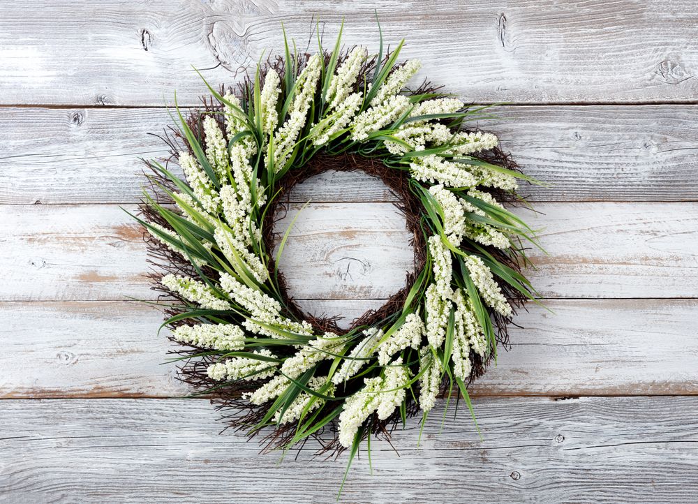 Natural flower wreath on weathered wooden background
