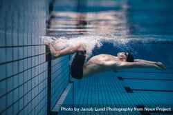 Male swimmer doing a flip turn underwater 49gny0