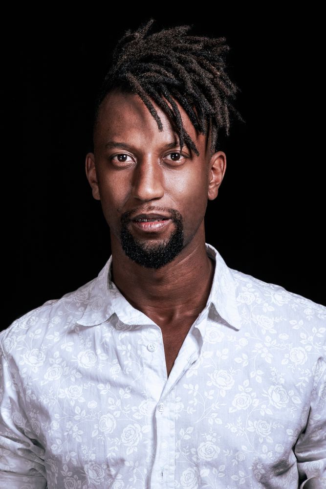 Portrait of Black man wearing light shirt