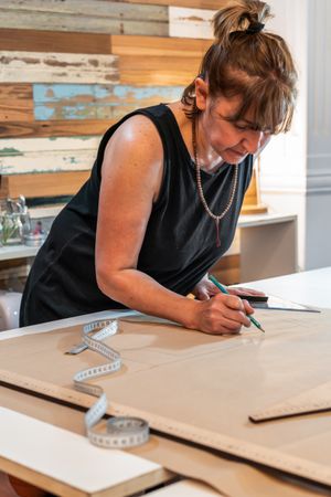 Fashion designer drawing fashion patterns. Vertical shot