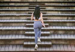 Anonymous woman standing on stairs