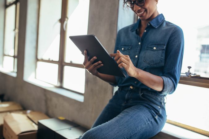 Female entrepreneur in office using digital tablet