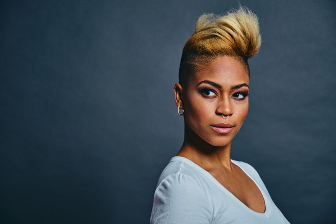 Portrait of proud Black woman with short blonde hair looking away from the camera