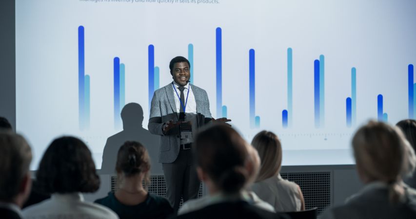 Successful Black Businessman Giving Presentation At International Business Conference.