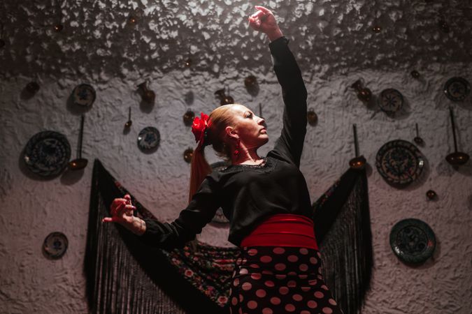 Woman dancer in flamenco costume standing in dance posture
