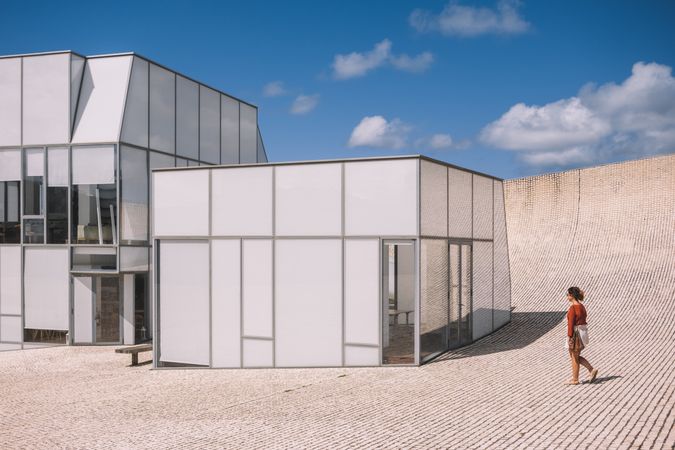 Woman next to contemporary building
