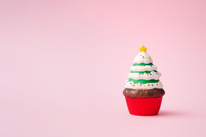 Christmas tree cupcake on pink background