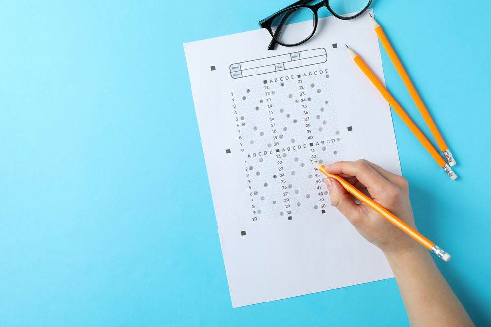 Top view of person taking multiple-choice exam