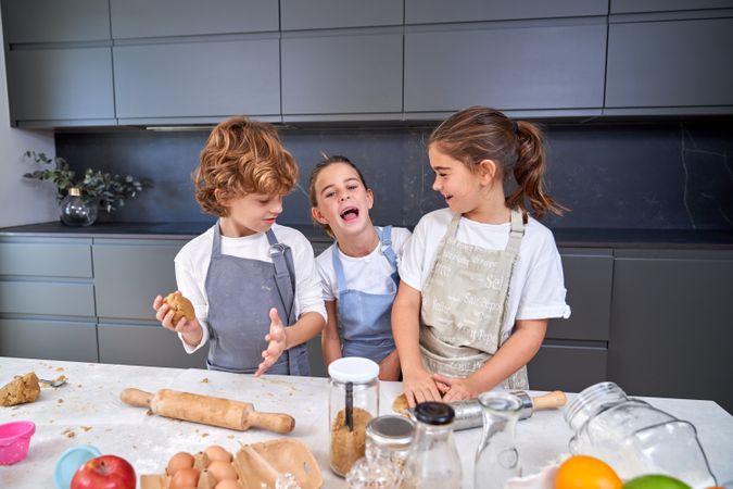 Happy children making cookie dough
