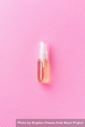 Small pink perfume over pink background 0v7go5