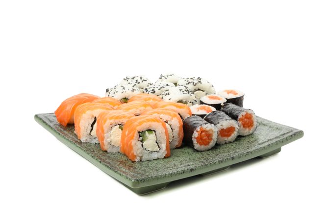 Tray with delicious sushi rolls isolated on light background