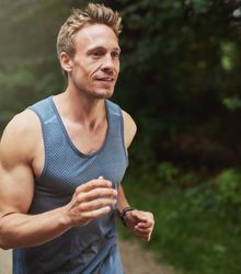 Athletic man in vest going for a jog