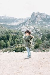 Boy walking on rocky hill