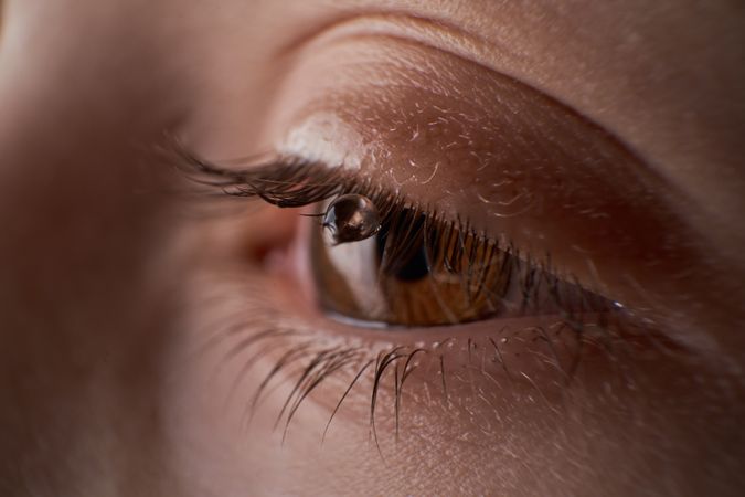 Eye of anonymous kid with tear