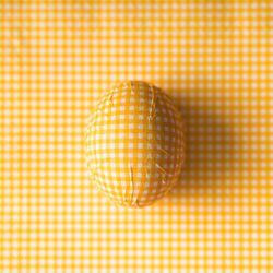 Yellow checkered Easter egg with matching background