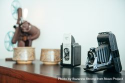 Close up of vintage film camera with vintage pottery and cameras in background 0KBqDb