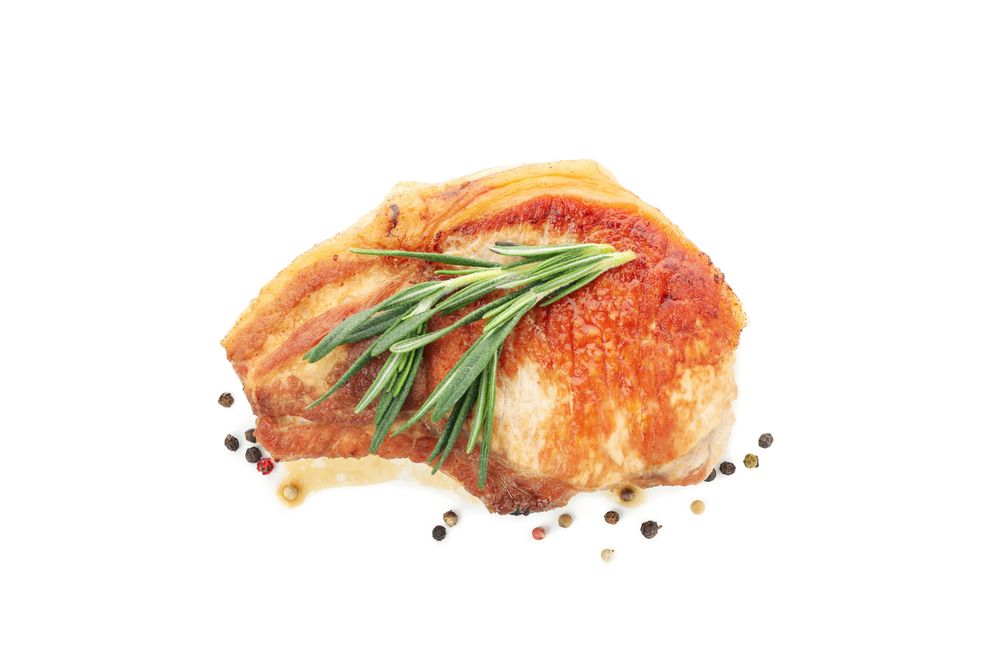 Fried pork steak isolated on light background. Grilled food