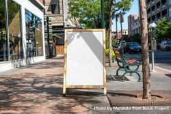 A-frame mockup on street on shops with tree shadow 0gKel0