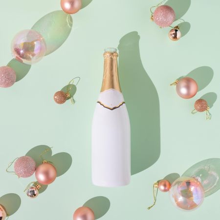 Top view of wine glass, Christmas decorations and champagne bottle
