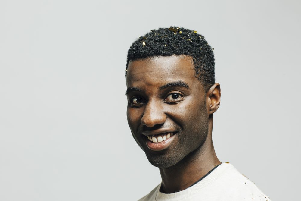 Close up portrait of a happy young man, isolated on studio background