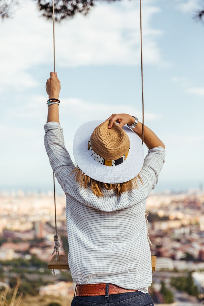 Woman with hat watching the city