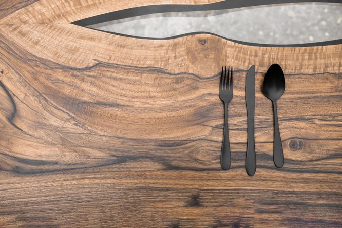 Dark cutlery on stylish wooden table