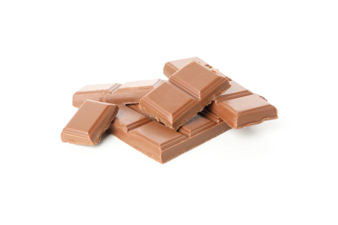 Tasty chocolate pieces isolated on studio background