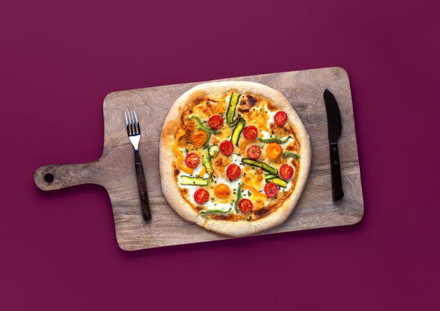 Homemade pizza primavera minimalist on a magenta table