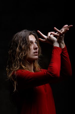 Young woman dancing in darkness