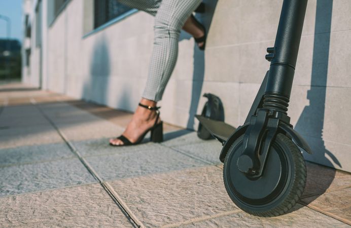 Electric scooter in the street and woman in background.
